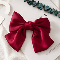 HKM-682899 Elegant Bow Hair Clip in Tribute Silk with Alloy Detailing and Elastic Band, Perfect for Special Occasions